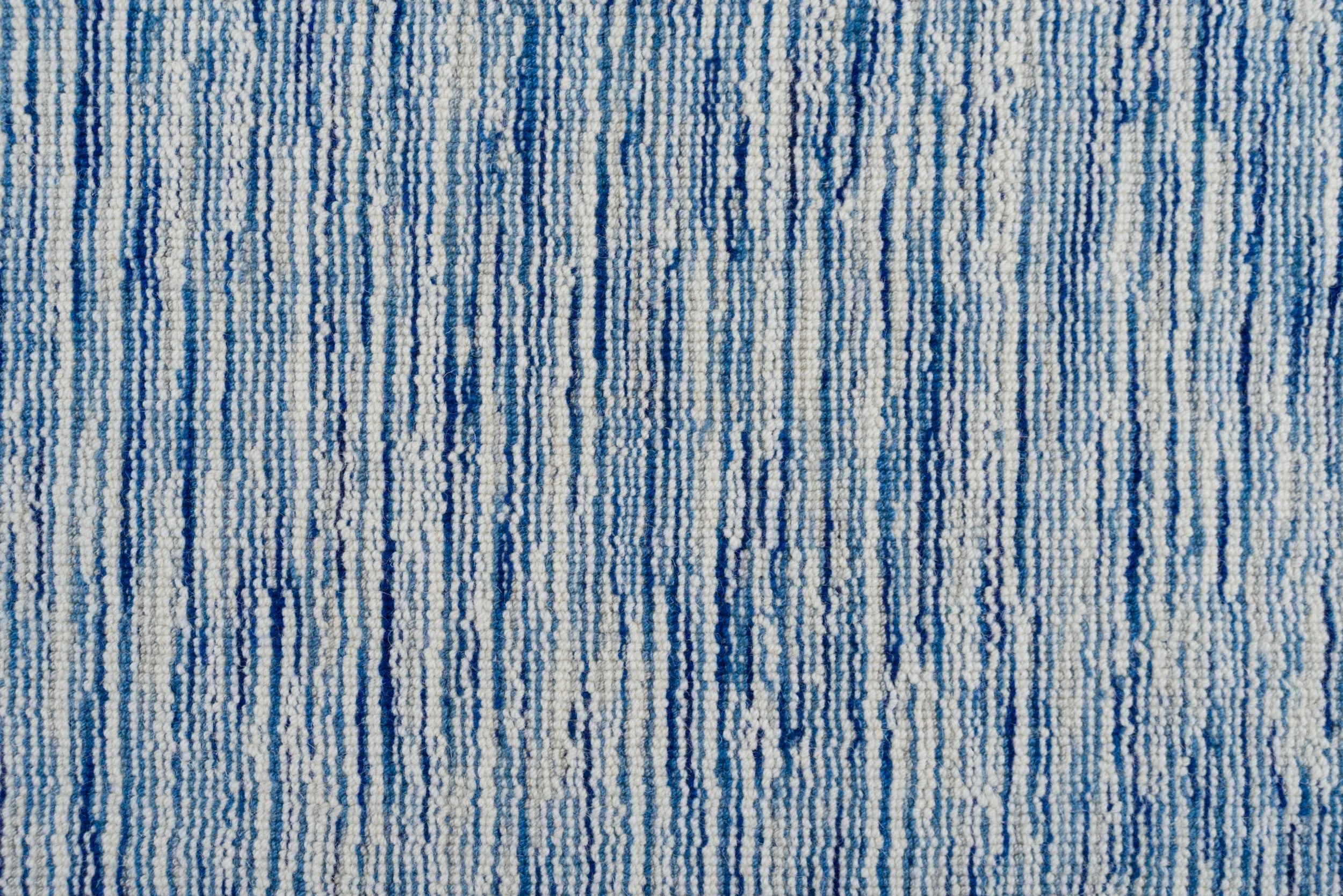 Broadloom carpet in a textural striated blue and white.