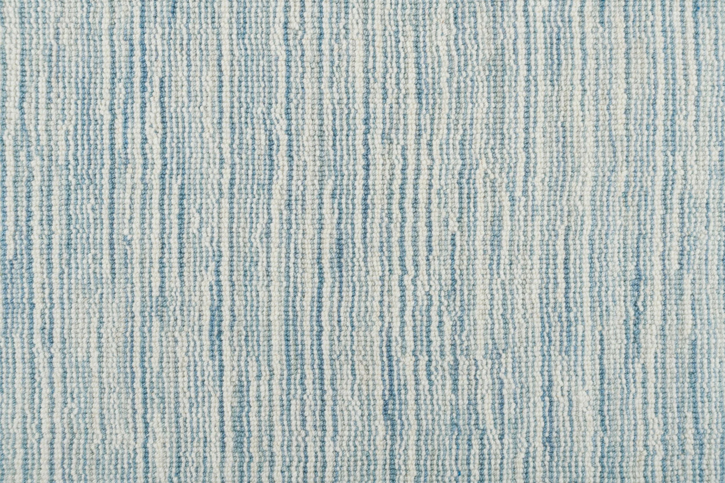 Broadloom carpet in a textural striated white and turquoise.