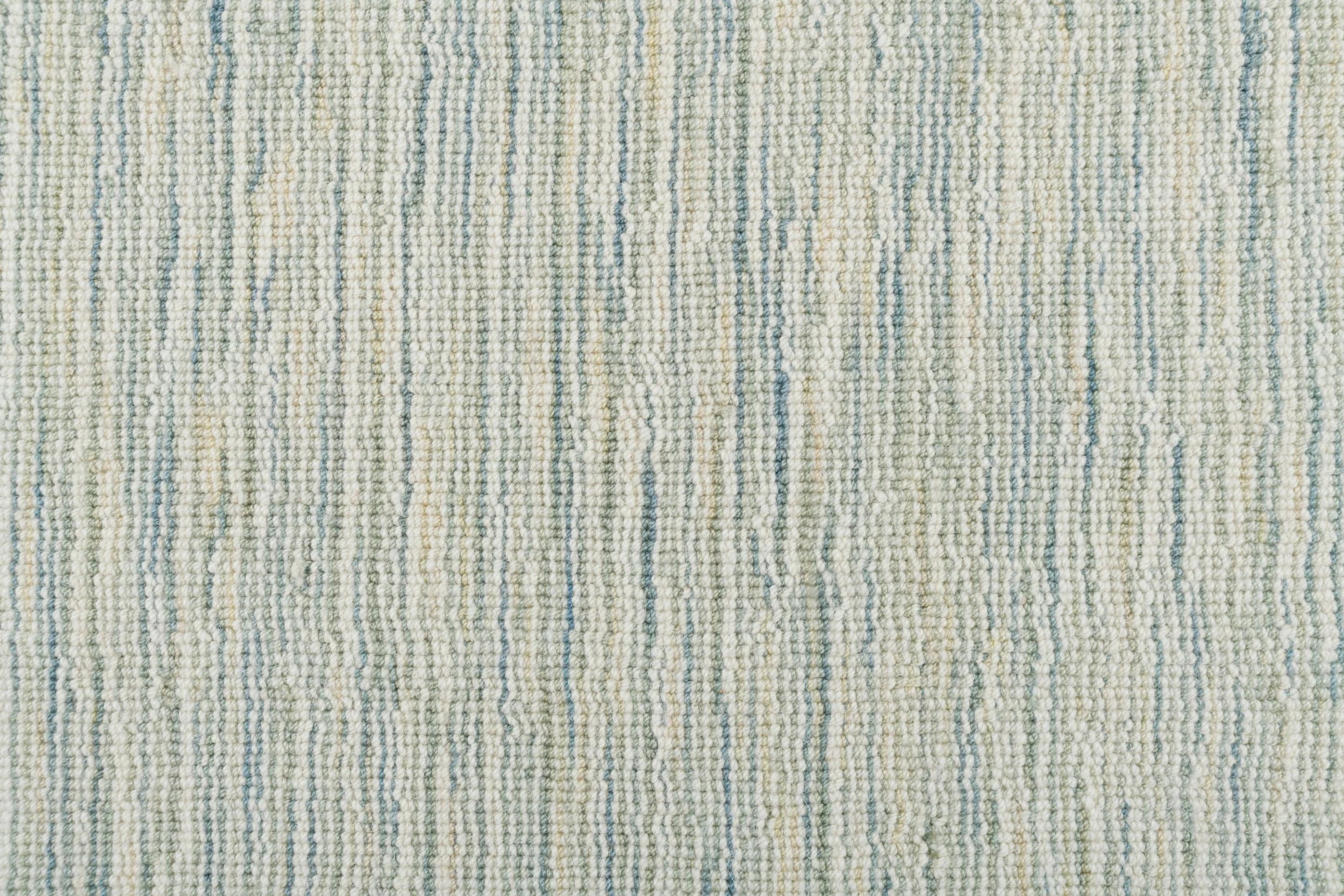 Broadloom carpet in a textural striated sage green.