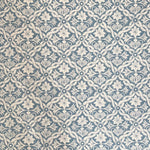 Detail of fabric in a floral lattice print in cream on a light blue field.