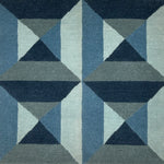 Geometric patterned rug with blue and gray triangles
