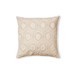 Square throw pillow with a dimensional floral medallion pattern embroidered in shades of beige on a cream field.