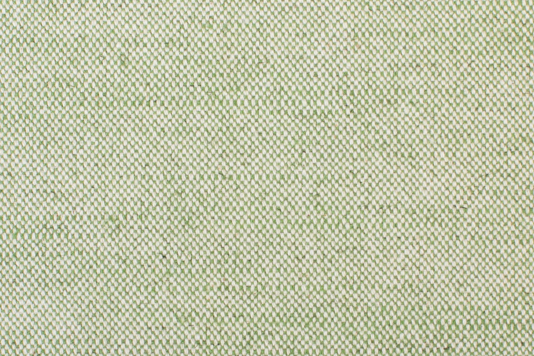 Detail of woven fabric yardage in textured cream and green.