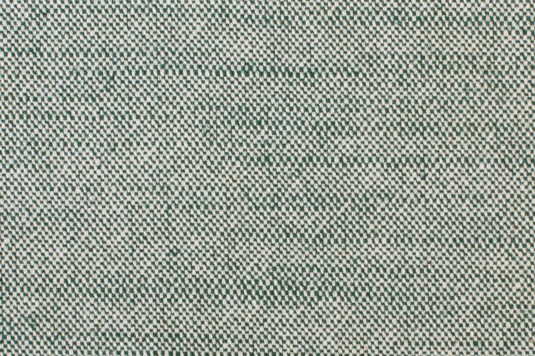 Detail of woven fabric yardage in textured cream and dark green.