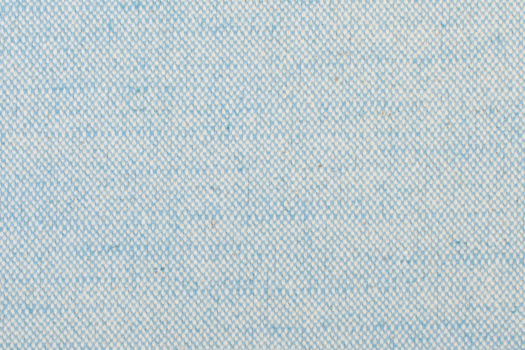 Detail of woven fabric yardage in textured cream and light blue.