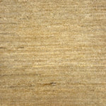 Textured handwoven carpet in beige.