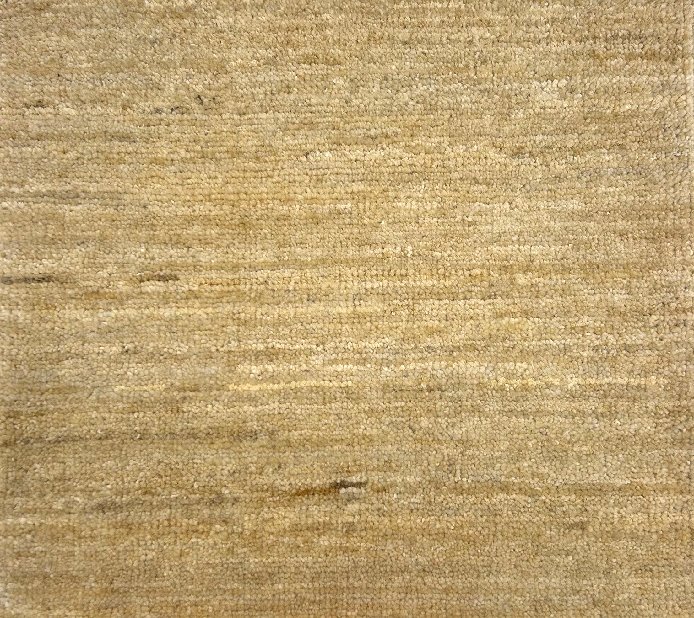 Textured handwoven carpet in beige.