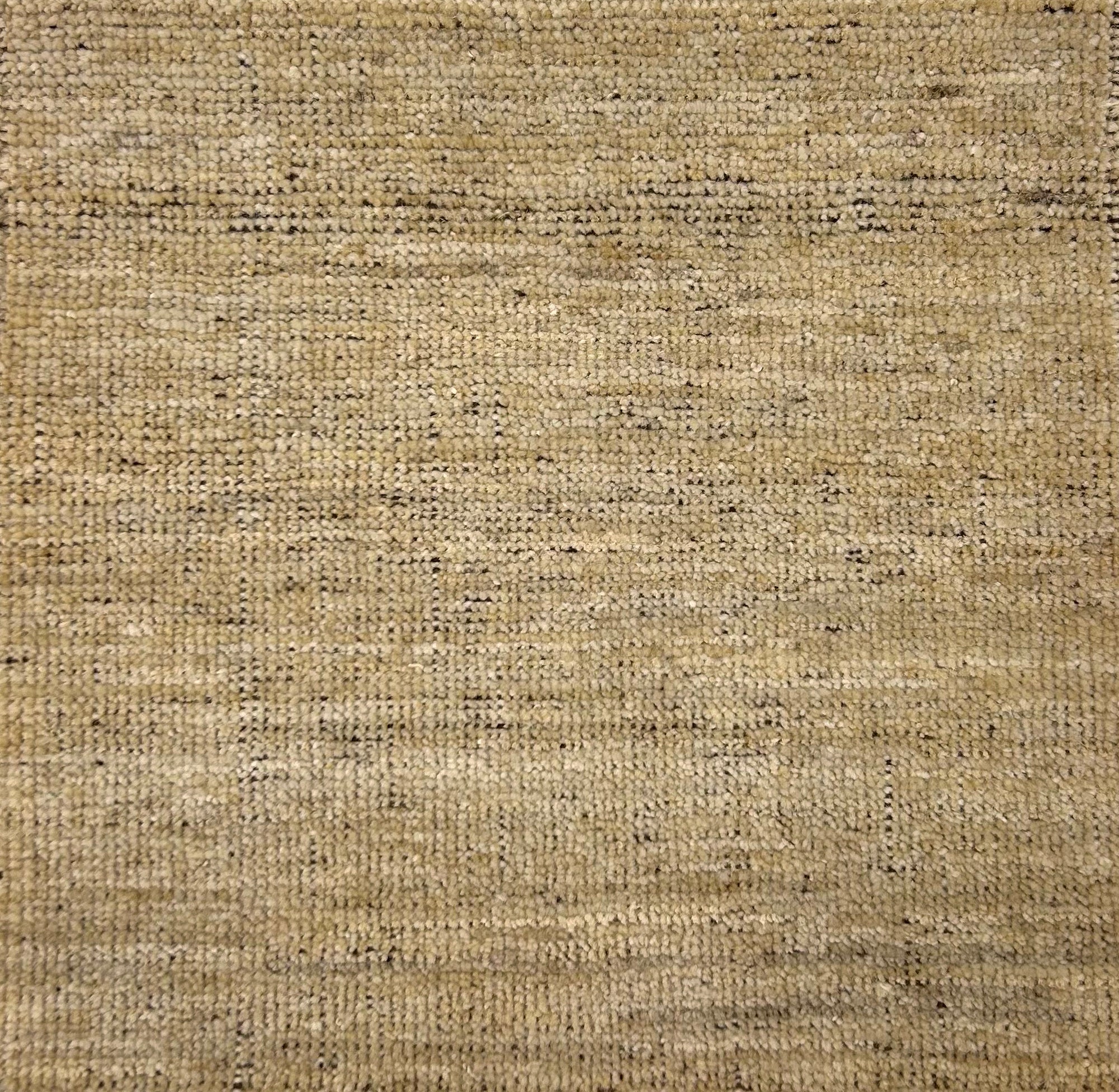 Textured handwoven carpet in beige. 