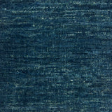 Textured handwoven carpet in teal blue.