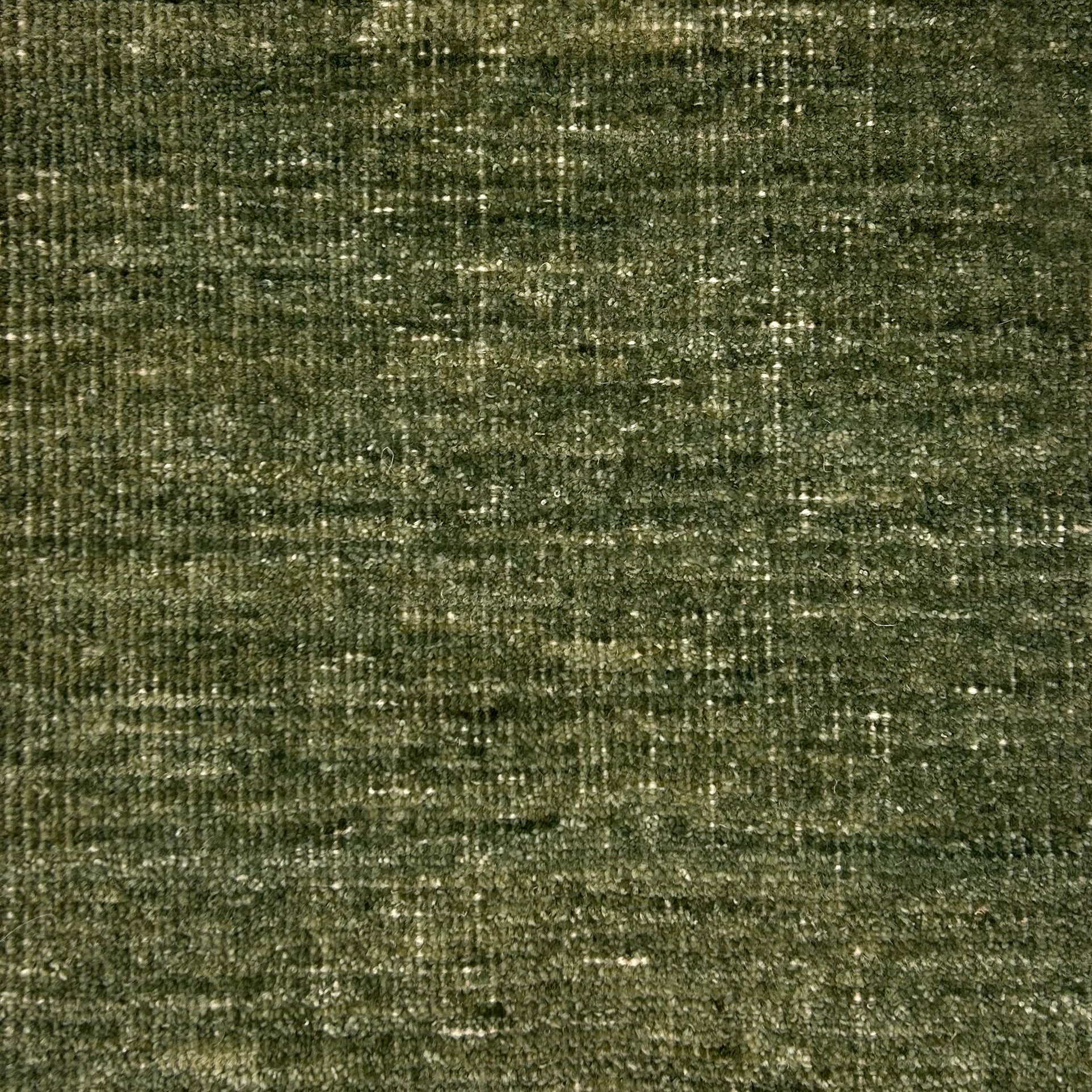 Textured handwoven carpet in green. 