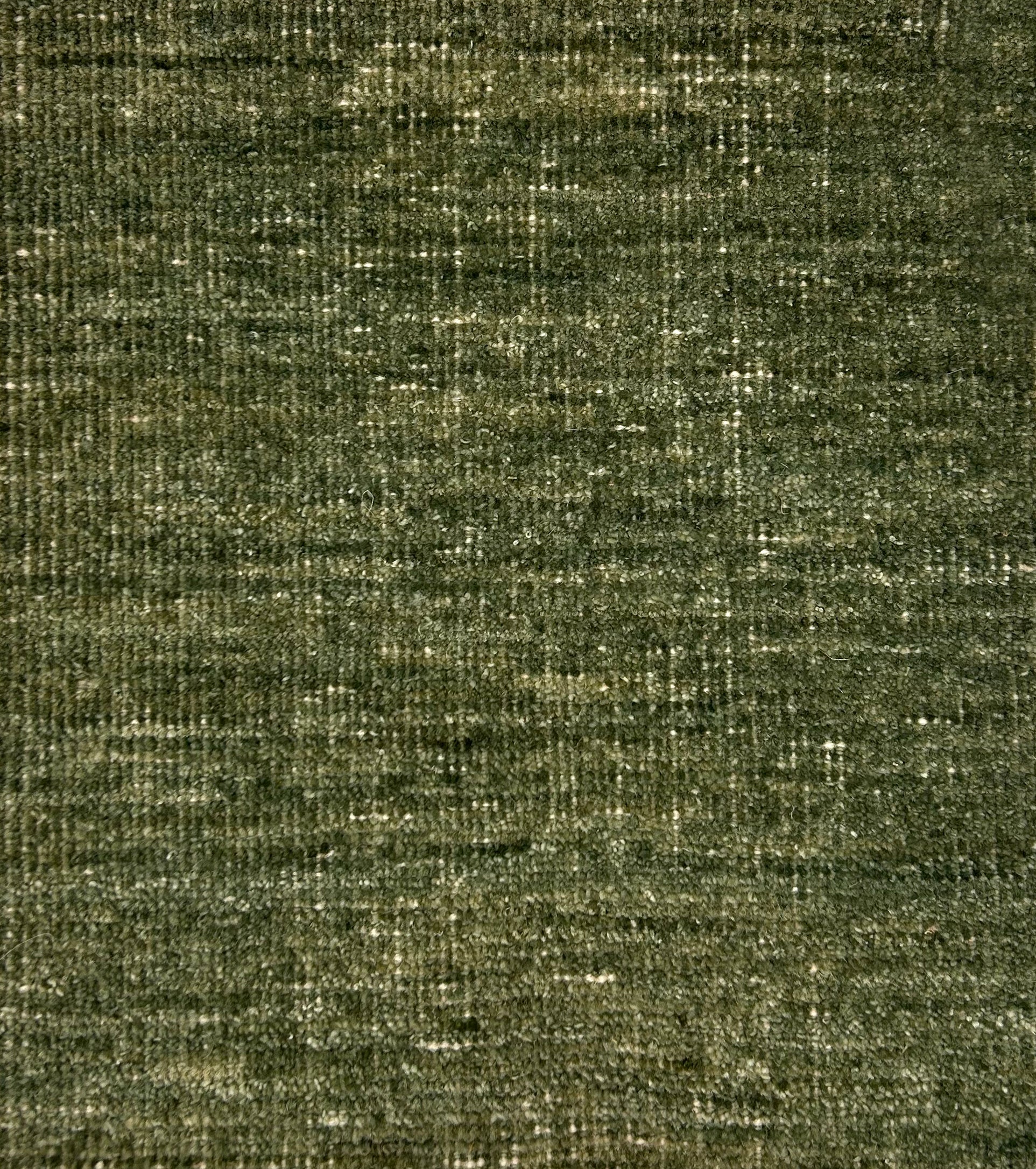 Textured handwoven carpet in green. 