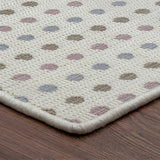 Patterned rug with multicolored dots on a wooden floor