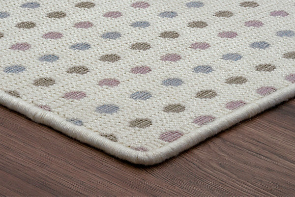 Patterned rug with multicolored dots on a wooden floor