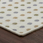 Close-up of a textured rug with a pattern on a wooden floor