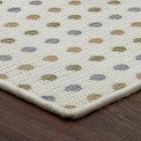 Close-up of a textured rug with a pattern on a wooden floor