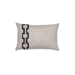 Rectangular throw pillow with an off-center stripe of geometric embroidery in shades of black, gray and blue on a greige field.