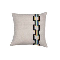 Square throw pillow with an off-center stripe of geometric embroidery in shades of black, orange, yellow and blue on a greige field.