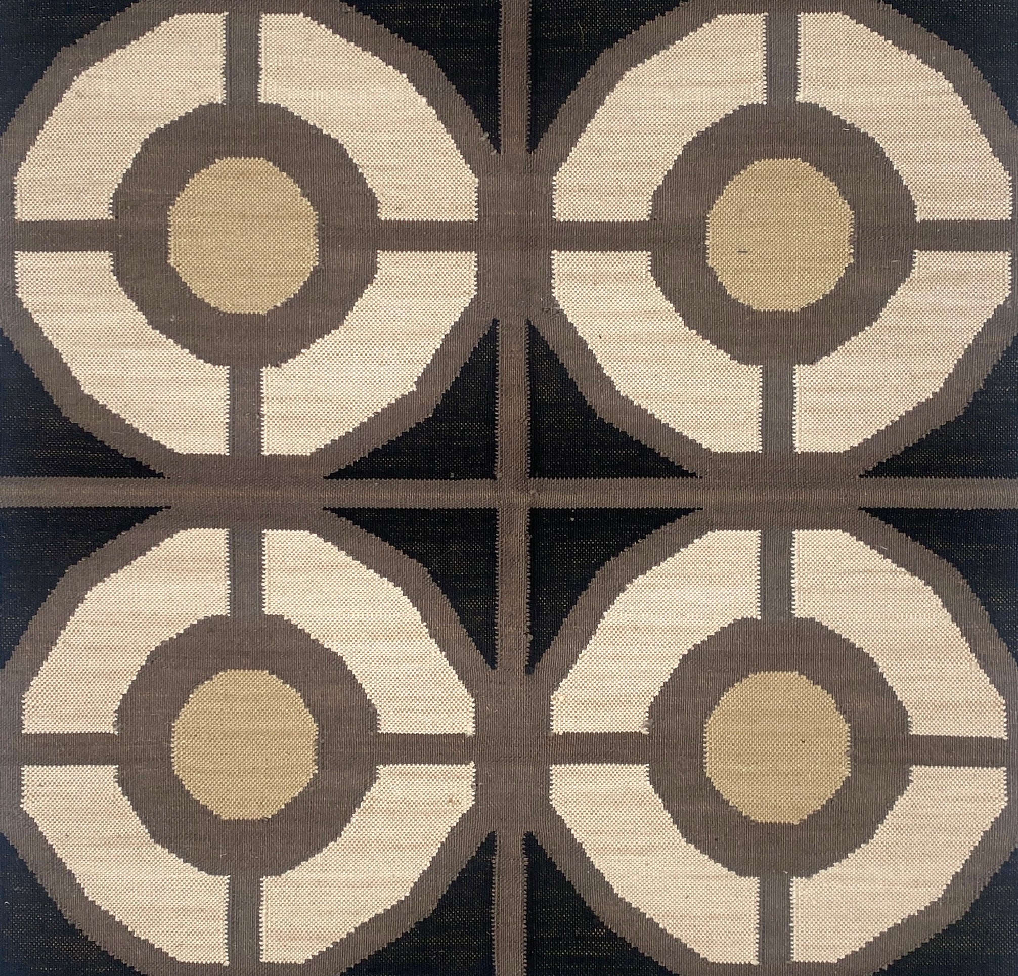 Patterned flatweave carpet with geometric design on a black background