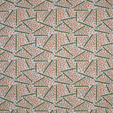 Printed fabric detail in a playful dot and line pattern in coral pink and green