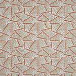 Printed fabric detail in a playful dot and line pattern in soft green and burnt orange