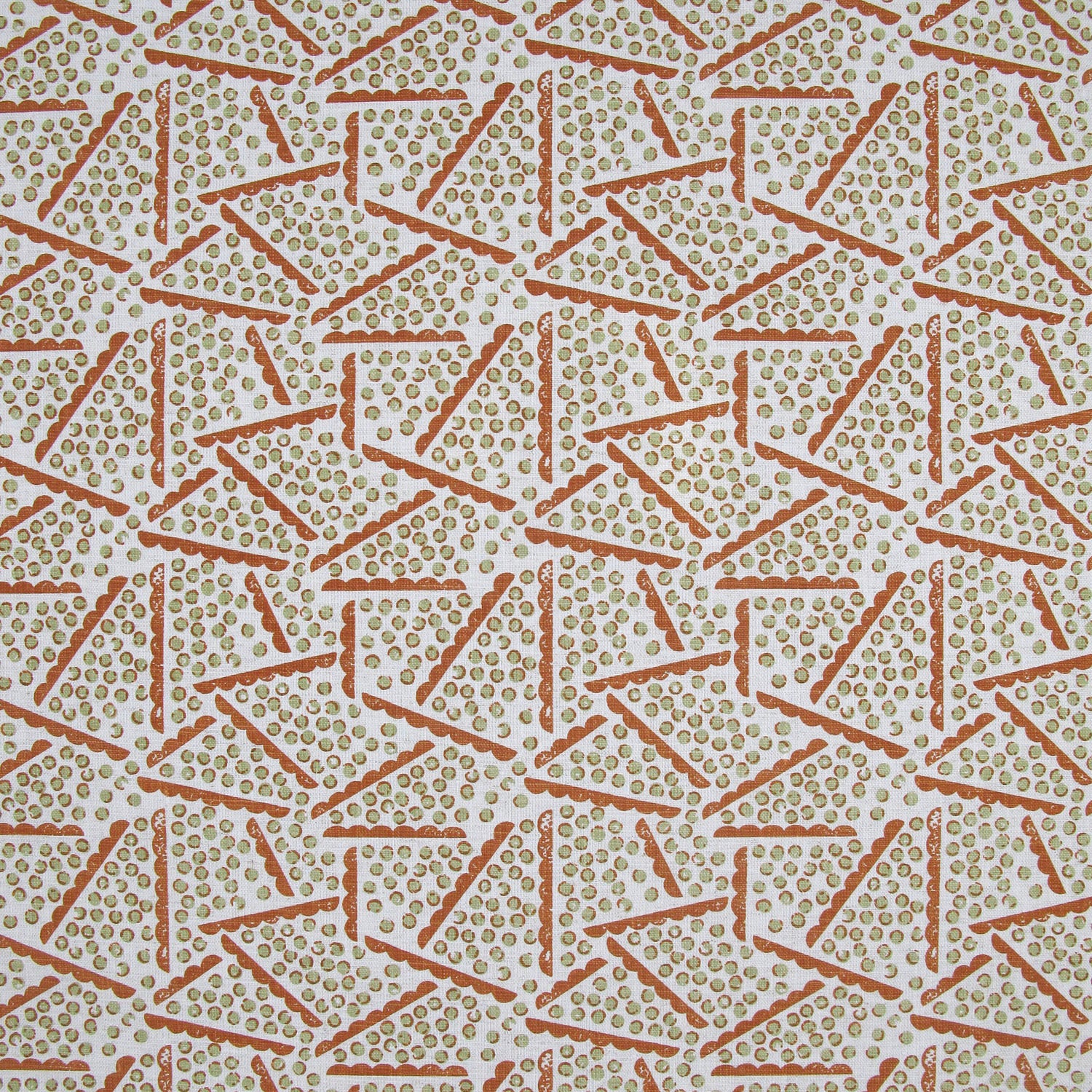 Printed fabric detail in a playful dot and line pattern in soft green and burnt orange