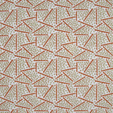 Printed fabric detail in a playful dot and line pattern in soft green and burnt orange