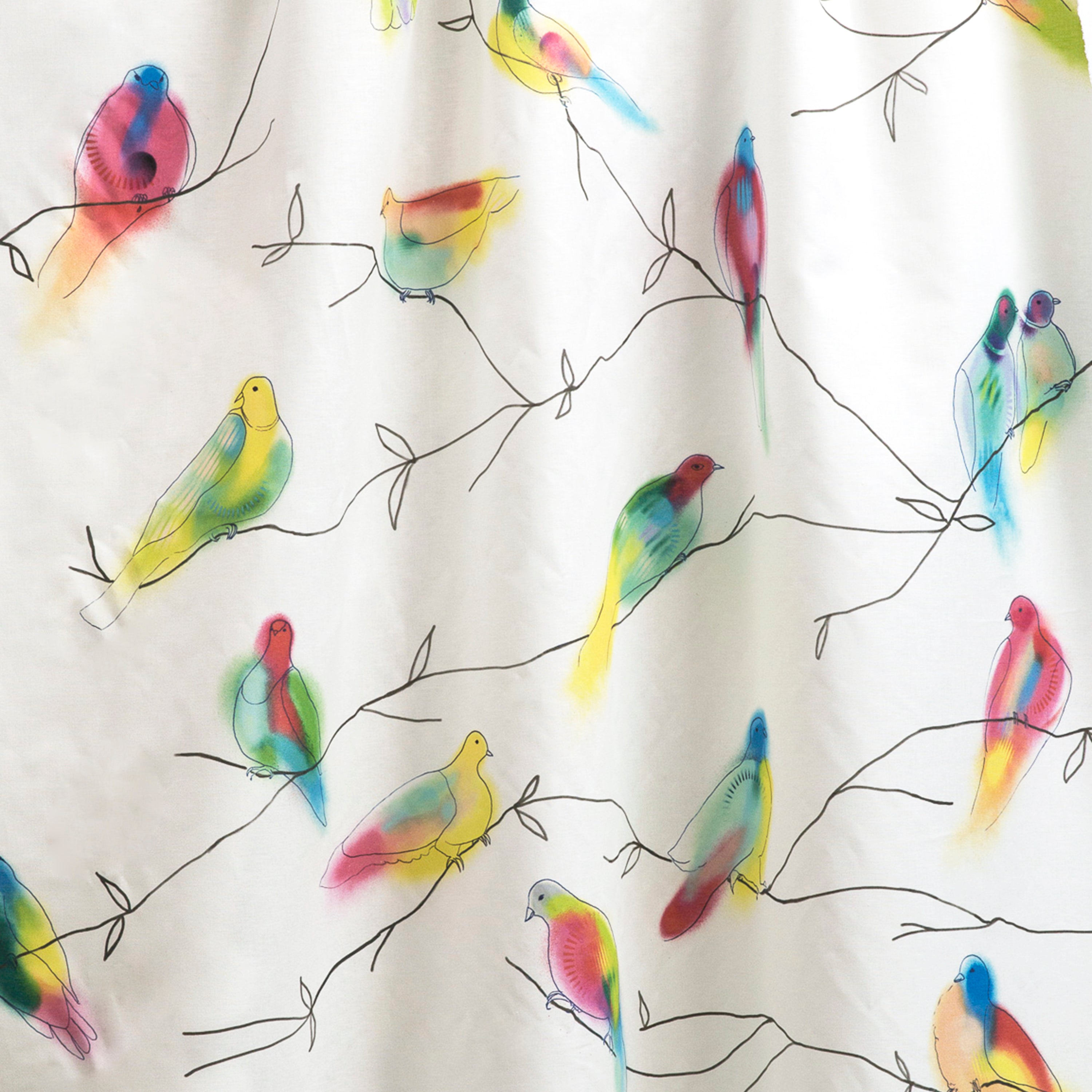 Draped fabric yardage in a painterly bird and branch print in green, yellow, pink and black on a white field.