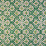 Detail of fabric in a playful floral grid print in green, yellow and blue on a white field.