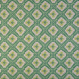 Detail of fabric in a playful floral grid print in green, yellow and blue on a white field.