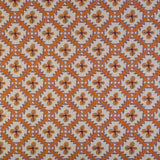 Detail of fabric in a playful floral grid print in orange, purple and green on a white field.