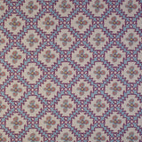 Detail of fabric in a playful floral grid print in blue, pink and purple on a white field.