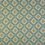 Detail of fabric in a playful floral grid print in green, yellow and blue on a white field.