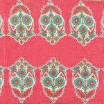 Detail of fabric in a repeating bird and floral paisley in turquoise, cream and red on a red field.