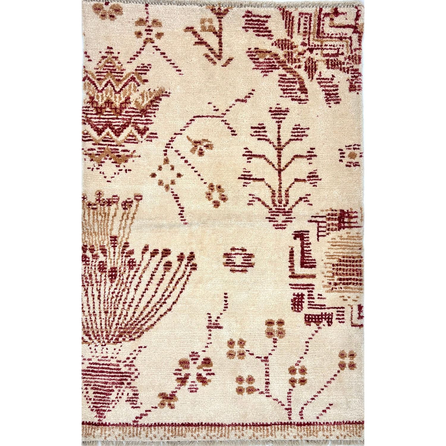 A rug with an ivory background and dark red and gold gforal pattern