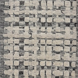 Handknotted rug sample in a textural geometric pattern in grey and ivory.