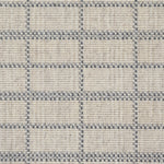 Broadloom carpet detail in plaid grid in shades of blue on a beige field.