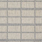 Broadloom carpet detail in plaid grid in shades of blue on a beige field.