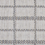 Broadloom carpet detail in plaid grid in shades of blue and brown on a beige field.