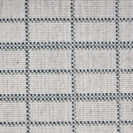 Broadloom carpet detail in plaid grid in shades of green on a beige field.