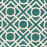 Detail of fabric in a geometric lattice print in turquoise on a cream field.