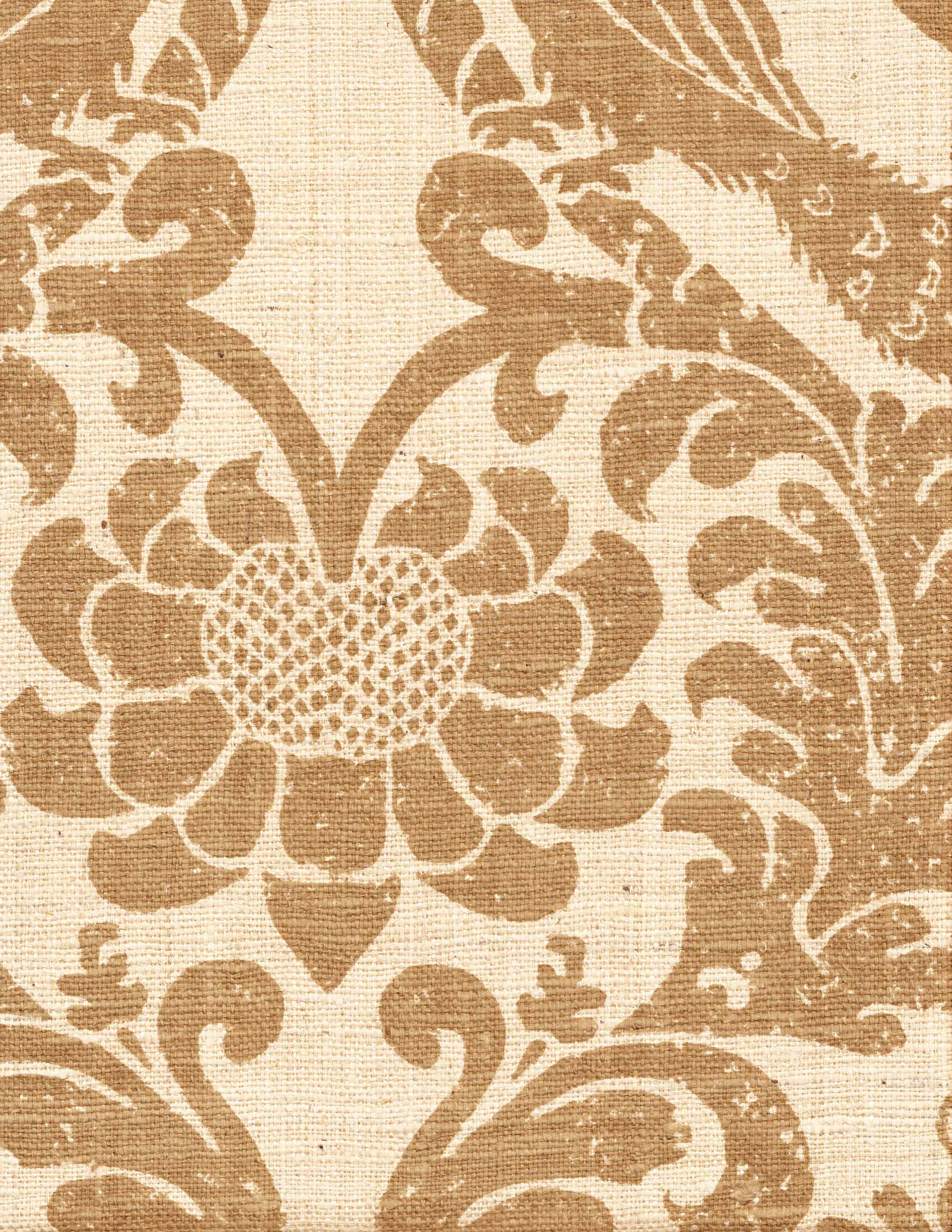 Detail of fabric in a botanical and bird print in brown on a cream field.