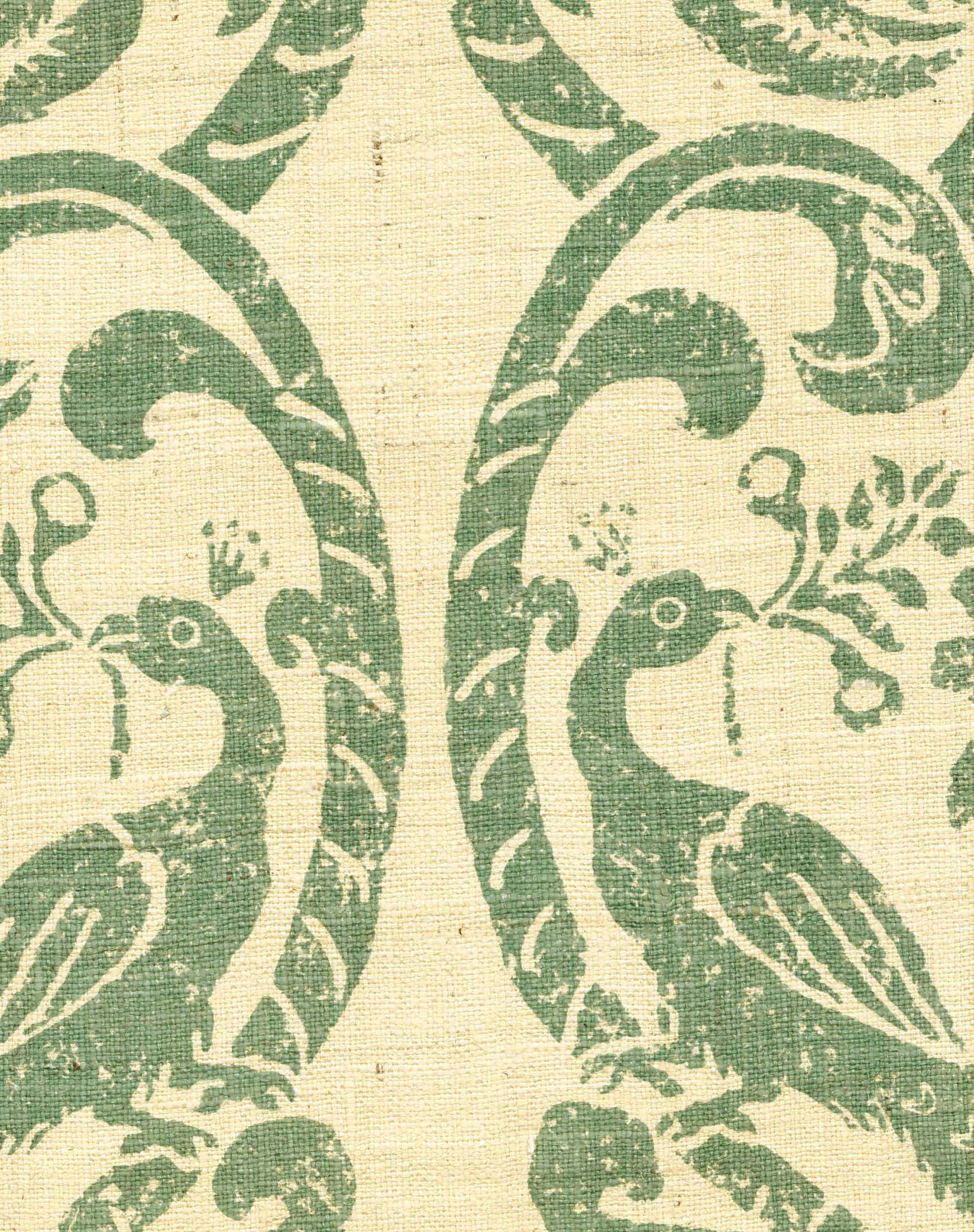 Detail of fabric in a botanical and bird print in dark turquoise on a cream field.