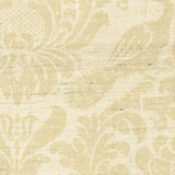 Detail of fabric in a botanical and bird print in tan on a cream field.