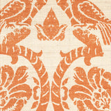 Detail of fabric in a botanical and bird print in orange on a cream field.