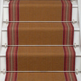 Striped flatweave runner in tan and red on white staircase