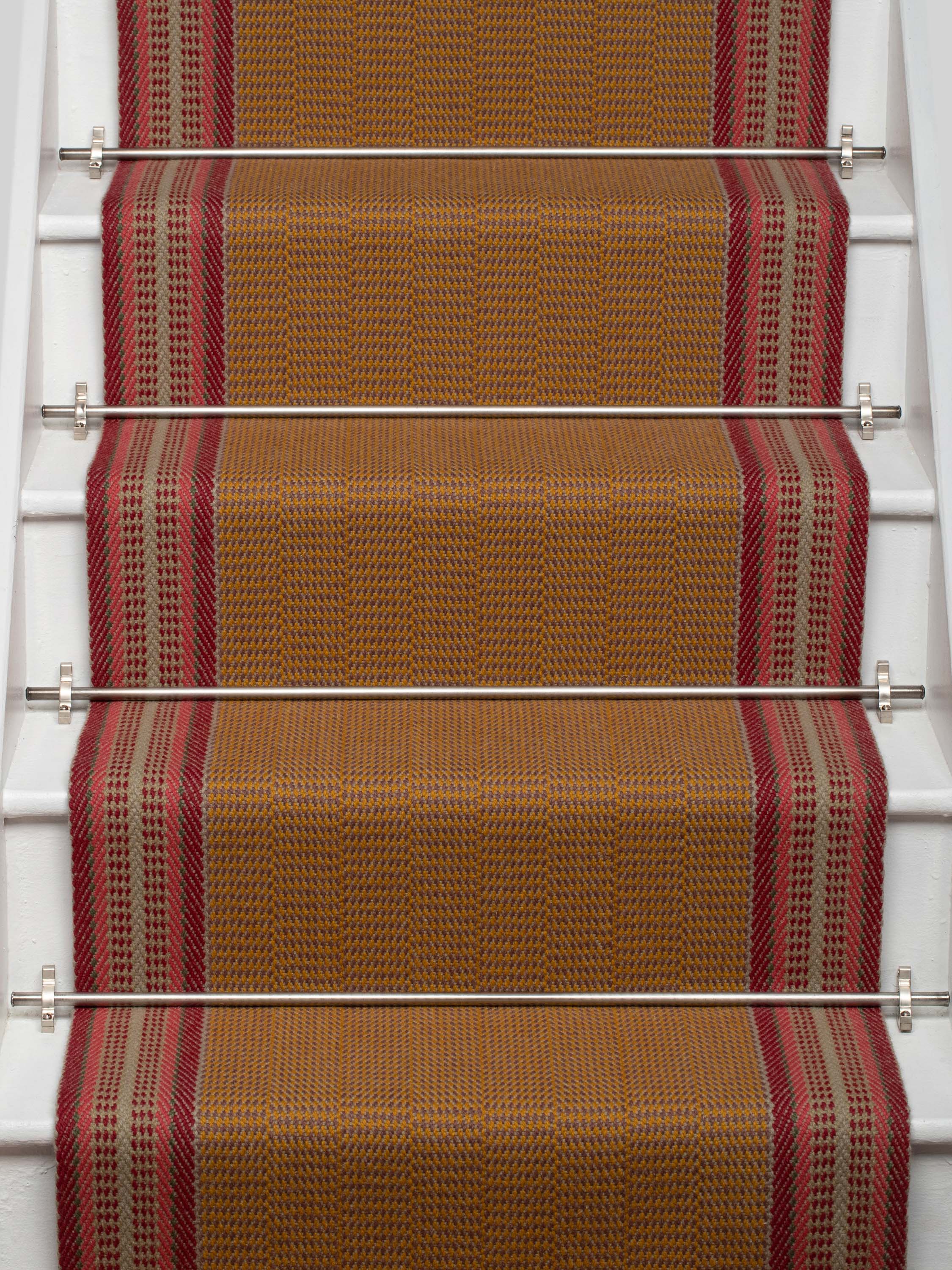 Striped flatweave runner in tan and red on white staircase