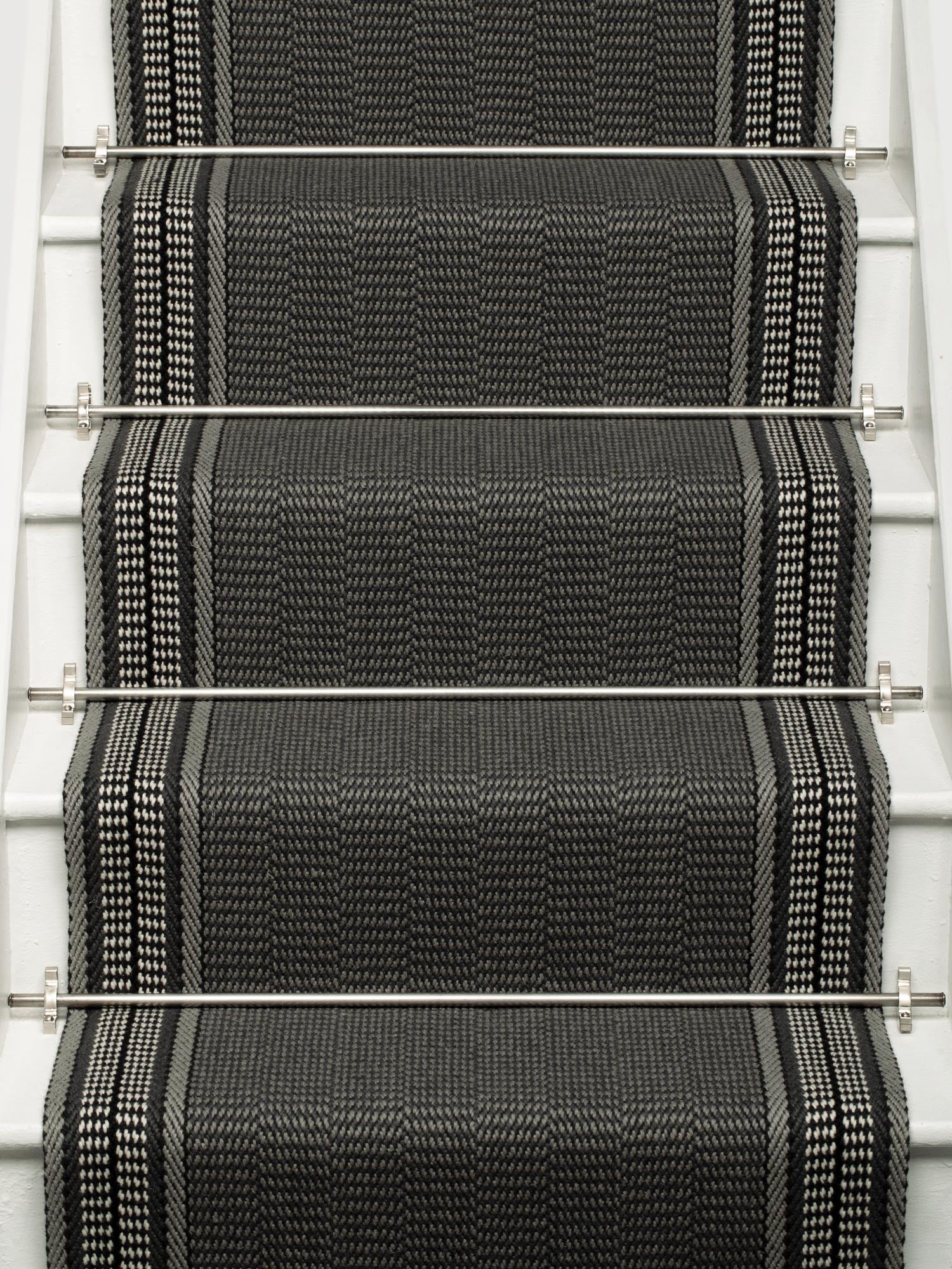 Striped flatweave runner in grey and black on white staircase