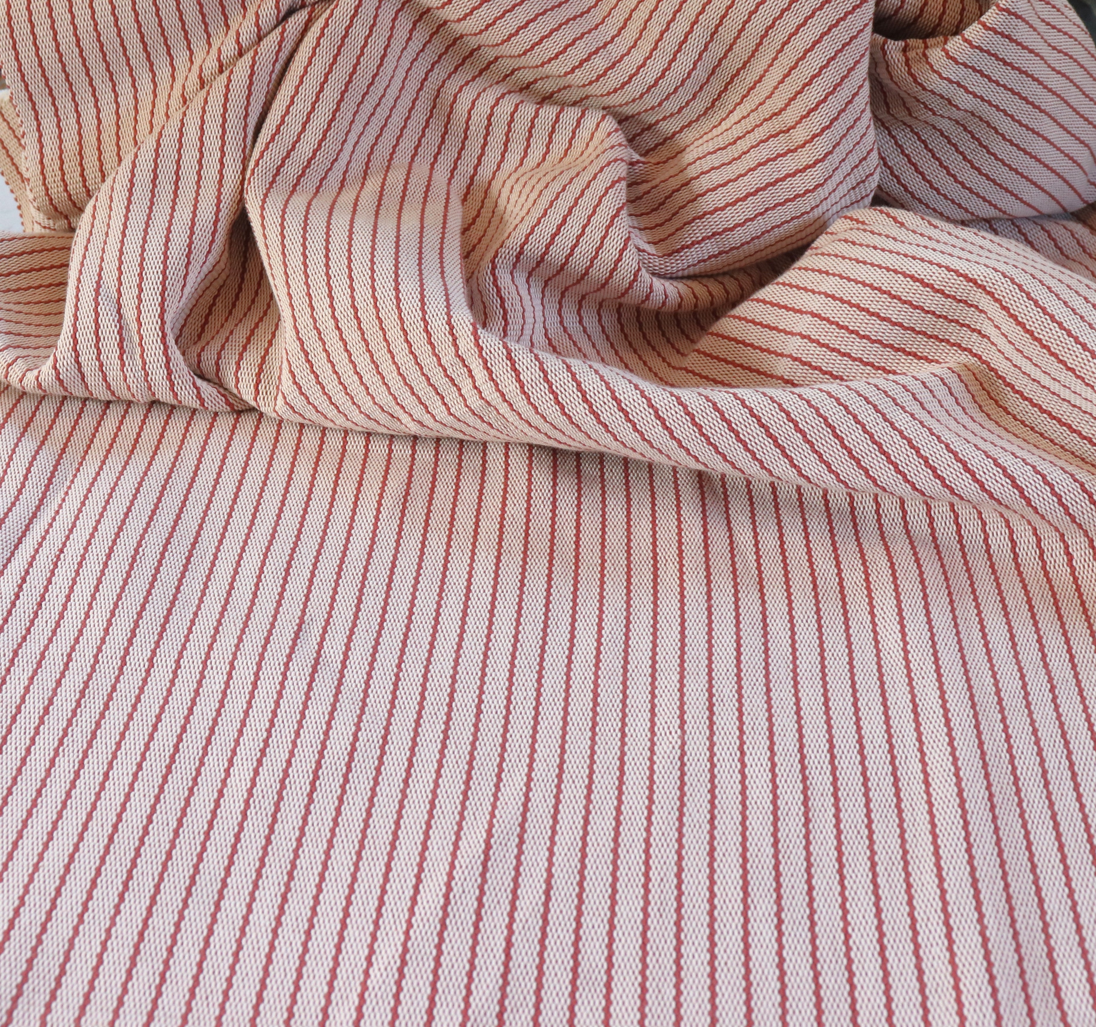 Draped close-up of pink and white striped fabric