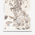 Roll of wallpaper with floral watercolor on a neutral background.