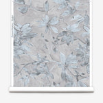 Wallpaper roll with floral pattern on a light gray background